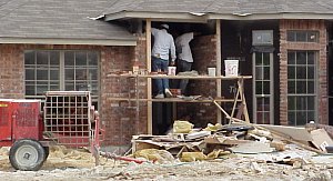 The workmen are bricking the front porch.