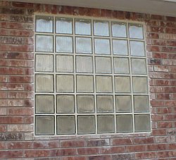 Glass blocks are being used in the bathrooms to provide privacy rather than regular glass windows.