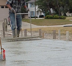 After the foundation is leveled, a jitterbug, a tool with a perforated bottom plate, is used to make sure that the top portion of concrete is free of solid matter.