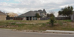 A picture of the vacant lot, from the front right corner.