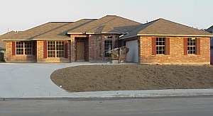 This picture of the house shows the shutters that have all been painted. 