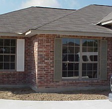 The shutters have been installed and need to be painted.